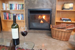 Wine by the fire on a rainy day fireplace